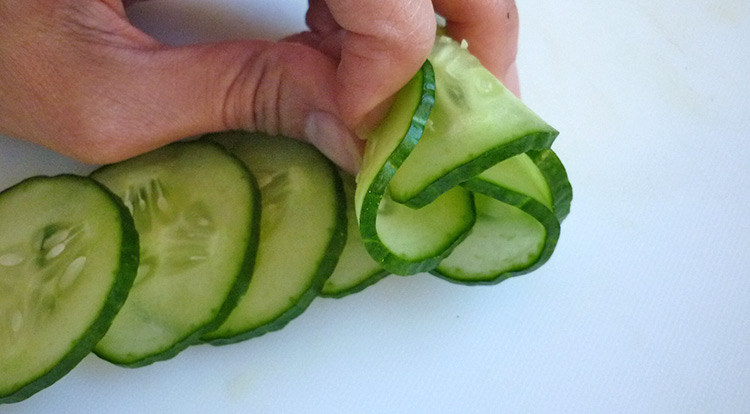 Cucumber flower with 12 petals, roll sliced cucumbers up step 2
